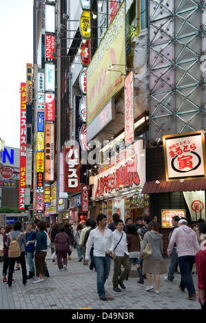 Neon advertising signs cover building facades in shopping and adult entertainment district Kabukicho in East Shinjuku, Tokyo Stock Photo