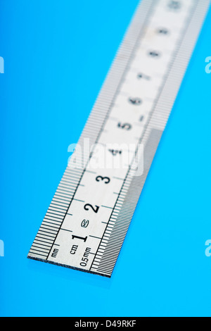 This is an image of a ruler, cut out over a blue background. Stock Photo