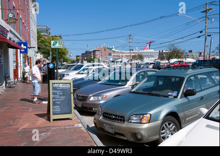 Man buying a parking ticket from an automatic dispenser in downtown Portland, Maine, USA. Stock Photo