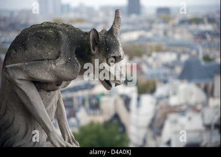 Stone gargoyle (Chimera) overlooking the city of Paris from the tower of the Notre Dame