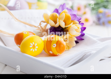 Spring flowers and Easter eggs decorating table Stock Photo