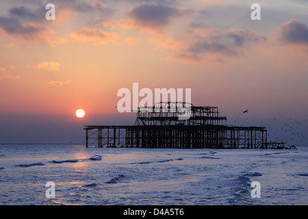 Sunset and Old pier, Brighton, England Stock Photo