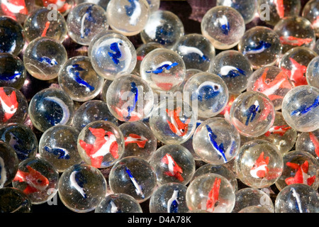 abstract full frame background with lots of colorful marbles made of glass in dark back Stock Photo