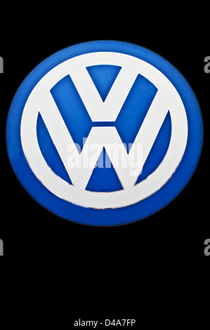A Volkswagen (VW) logo on black background. Stock Photo