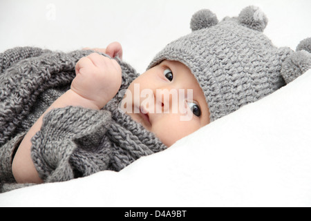 Beautiful baby in gray knitted hat Stock Photo