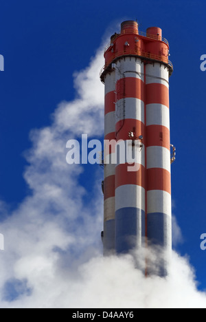 Smoke surrounding industrial chimneys Stock Photo