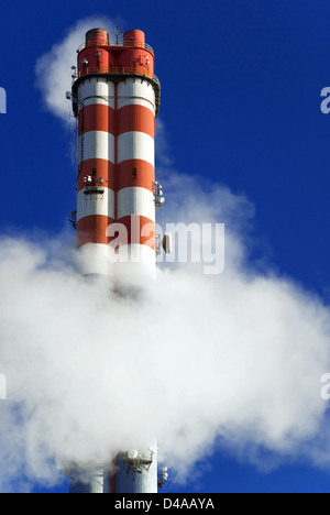 Smoke surrounding industrial chimneys Stock Photo