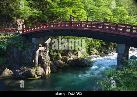 The Futarasan Shrine Shinkyo sacred bridge over a clear water stream in Nikko, Tochigi, Japan.