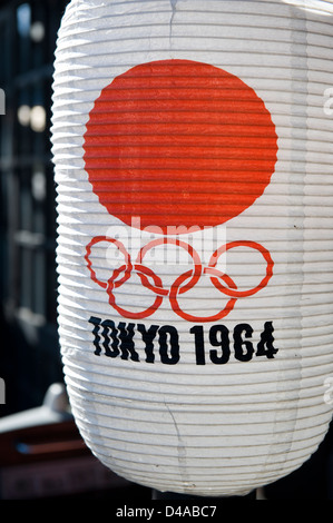 A paper chochin lantern from the 1964 Tokyo Olympic Games with a red rising sun against a white background. Stock Photo