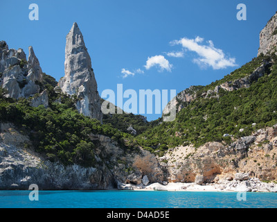Aguglia pinnacle famous for rock climbing on the deserted Cala Goloritze beach, only accessible by boat, in the Gulf of Orosei. Stock Photo
