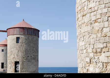 Rhodes. Greece. Medieval windmills located on the promontory which overlooks Mandraki harbour in Rhodes town Stock Photo
