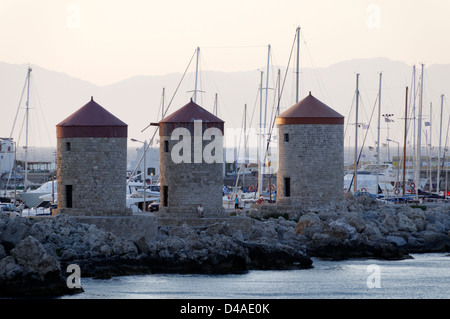 Rhodes. Greece. Three medieval windmills located on the promontory which overlooks Mandraki harbour in Rhodes town. Stock Photo