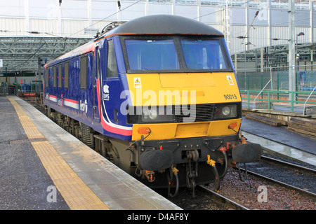 First Scotrail liveried  class 90 electric locomotive waits for its next duty at a platform at Edinburgh Waverley station. Stock Photo