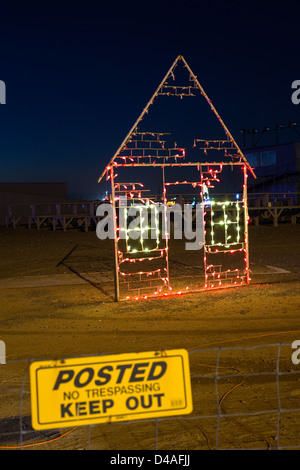 A neon light sculpture showing a house and a keep out sign in front, Christmas decoration at Arizona Celebration of Lights show. Stock Photo