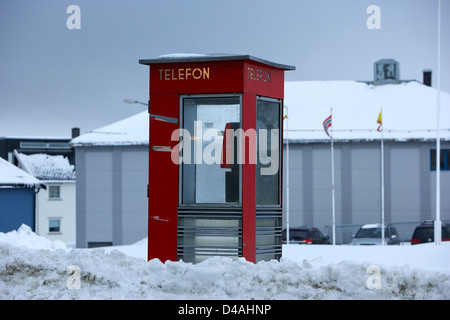 red norwegian telenor telefon box buried in the snow norway europe Stock Photo