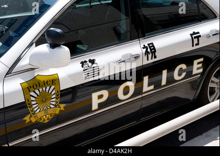 Detail of Japanese police car with English language written on door in Tokyo, Japan Stock Photo