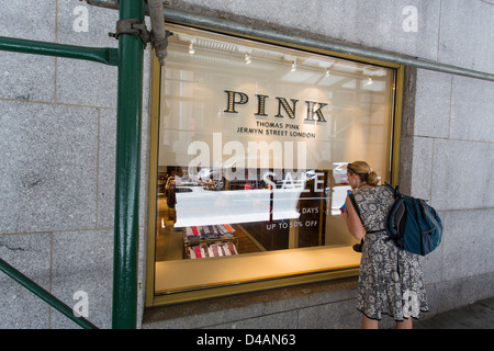 Young lady looking at the windows display of the PINK store in Manhattan, NYC Stock Photo