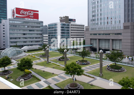'Field of Green' grassy park-like public space with criss-cross sidewalks at Oasis 21 retail complex in Sakae, Nagoya, Japan. Stock Photo