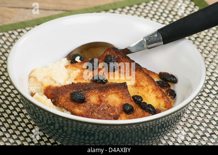Serving of home made bread and butter pudding in a bowl Stock Photo