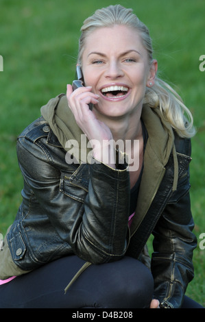 Woman on mobile phone in the park Stock Photo