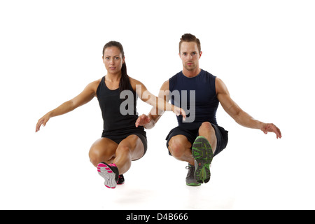 Beautiful young couple doing one leg squat fitness exercise Stock Photo