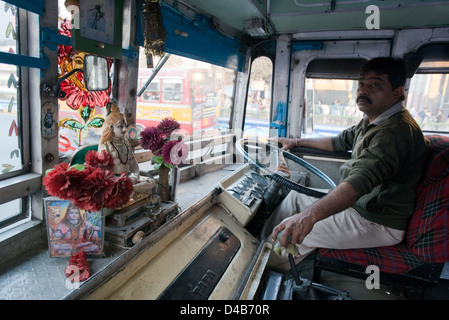 A shrine to the Hindu God Shiva sits on the dashboard of a bus In Kolkata, India Stock Photo