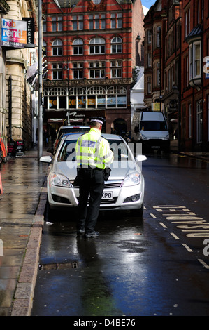 Penalty Charge Notice.Civil Enforcement Officer Issues Ticket for Disabled Driver . Stock Photo