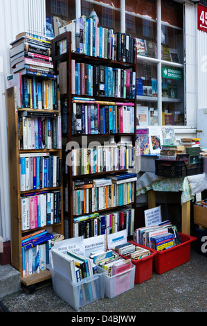 Books stacked on shelves and in boxes outside a secondhand bookshop. Stock Photo