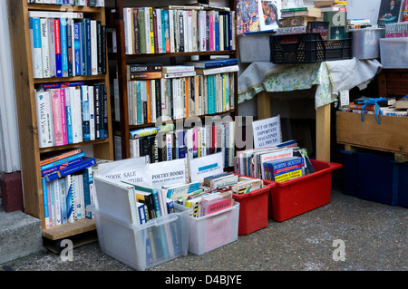 Books stacked on shelves and in boxes outside a secondhand bookshop. Stock Photo