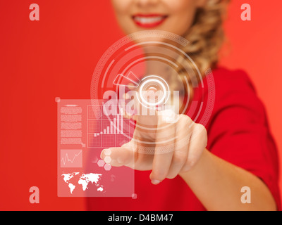 woman in red dress pressing virtual button Stock Photo