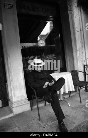Gondolier texting, Venice Stock Photo