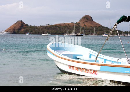 A view of Pigeon Island in St Lucia with a water taxi in the foreground Stock Photo