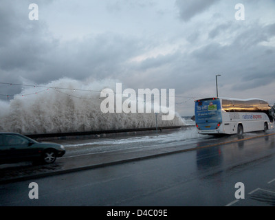 Torquay seafront, March 11th 2013. High waves crash over the sea wall and traffic, as storms and rain hit the South Devon Coast Stock Photo