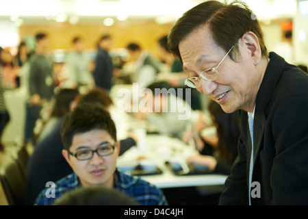 Jonney Shih, Chairman of ASUS, interacts with young engineers in the cafeteria at the ASUS Headquarters in Taiwan. Stock Photo