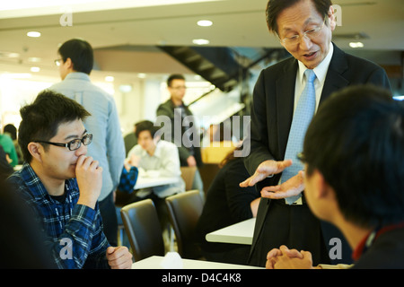 Jonney Shih, Chairman of ASUS, interacts with young engineers in the cafeteria at the ASUS Headquarters in Taiwan. Stock Photo