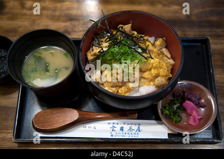 Teishoku lunch set 'oyakodon' ('parent and child' or chicken and egg bowl) with miso soup and otsukemono pickled garnishes. Stock Photo