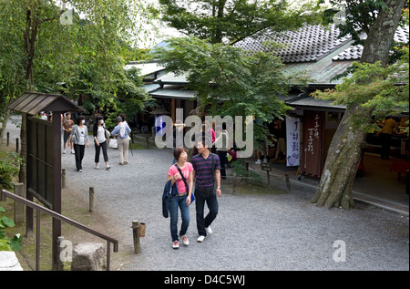 Visitors enjoying a stroll along a pathway in the rural mountain village of Ohara, Kyoto, Japan. Stock Photo