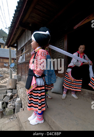 A Long Horn Miao teenage girl getting ready for the Tiao Hua festival in Guizhou. Stock Photo