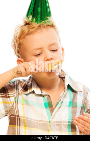 Little blond boy eating his birthday cake - portrait isolated on white Stock Photo