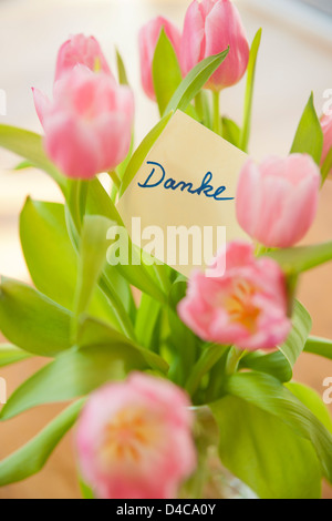 "Tahnk you" note in a tulpin bunch Stock Photo