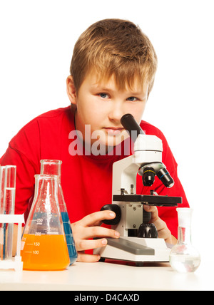 Cute Caucasian boy in lab with microscope and test laboratory equipmen Stock Photo