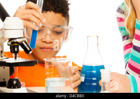 Boy and chemistry - 8 years old mixing liquids in test tubes and flasks Stock Photo