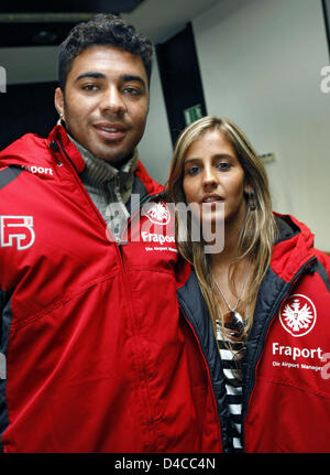 Bundesliga club Eintracht Frankfurt new signed attacking midfielder Caio (L) and his girl-friend Bruna Umann (R) like their new Eintracht Frankfurt tracksuits as they arrive at the airport of Frankfurt Main, Germany, 15 January 2008. The 21-year-old penned a four-years contract the previous day with Eintracht Frankfurt, that signed their preferred player from Brazilian Serie A top  Stock Photo