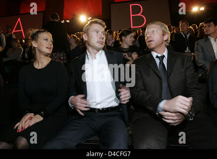 Singer and TV presenter Barbara Schoeneberger, former Finnish Formula One driver Mika Hakkinen (C) and former German  tennis star Boris Becker attend a fashion show of 'Hugo' creations during the Berlin Fashion Week at Tempelhof airport in Berlin, 27 January 2008. For the fall and winter season 2008/2009 label Hugo Boss presented creations by Belgian fashion designer Bruno Pieters. Stock Photo