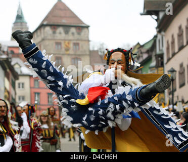 A traditional 'Federa-Hannes' carnival figure jumps into the air during the traditional 'Narrensprung' (lit.: Fool's Jump) carnival celebration in Rottweil, Germany, 04 February 2008. According to the police the Narrensprung parade of some 3,500 costumed participants attracted more than 25,000 spectators. Photo: PATRICK SEEGER