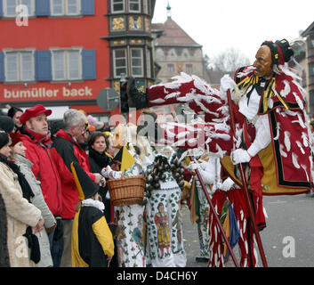 A traditional 'Federa-Hannes' carnival figure jumps into the air during the traditional 'Narrensprung' (lit.: Fool's Jump) carnival celebration in Rottweil, Germany, 04 February 2008. According to the police the Narrensprung parade of some 3,500 costumed participants attracted more than 25,000 spectators. Photo: PATRICK SEEGER