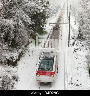 modern train passing through snowy countryside in winter Stock Photo
