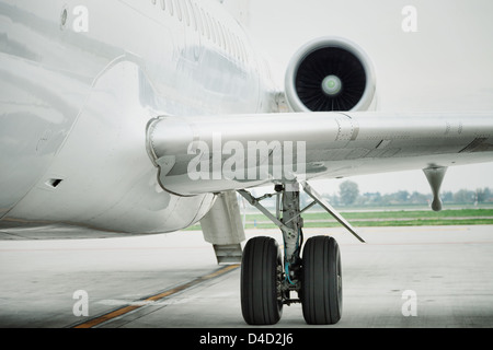 wing and engine of passenger airplane in airport Stock Photo