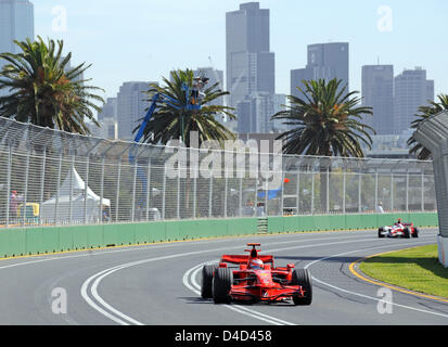 Finnish Formula One driver Kimi Raikkonen (front) of the Ferrari team and Japanese Takuma Sato (rear) of the Super Aguri team steer their cars in front of the skyline during the first practice session at Albert Park Circuit in Melbourne, Australia, 14 March 2008. The Australian Formula One Grand Prix will take place on Sunday 16 March. Photo: GERO BRELOER Stock Photo