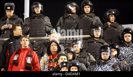 Two fans of Leverkusen follow the action surrounded by policemen during the 2nd leg of UEFA Cup quarter-final soccer match Zenit Saint Petersburg vs. Bayer Leverkusen, in Saint Petersburg, Russia, 10 April 2008. Photo: ROLF VENNENBERND Stock Photo